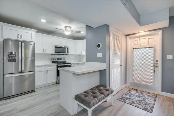 a kitchen with stainless steel appliances granite countertop a refrigerator stove and sink