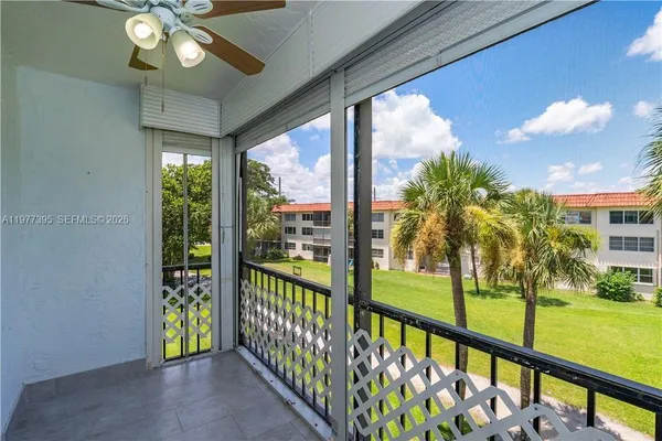 a bedroom with a large bed and a large window