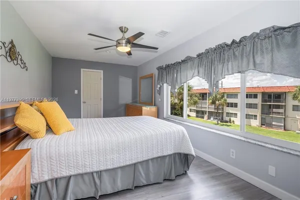 a bedroom with a bed and a large window