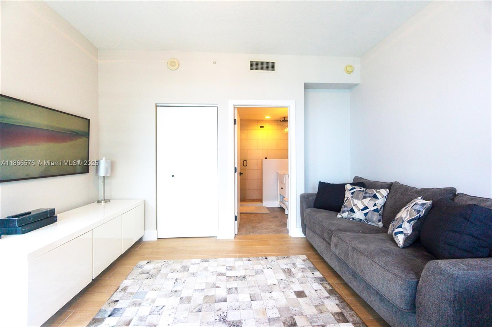 60 Southwest 13th Street, Unit 4802 Miami, FL 33130 - Photo 14 of 23 a living room with a couch and a coffee table