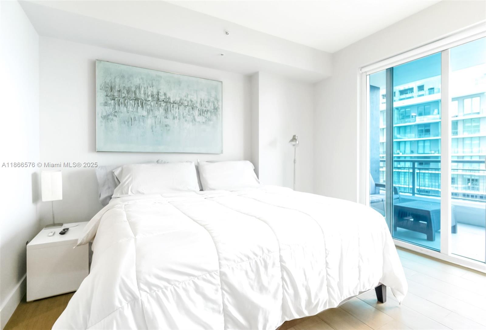 60 Southwest 13th Street, Unit 4802 Miami, FL 33130 - Photo 15 of 23 a spacious bedroom with a bed and a window