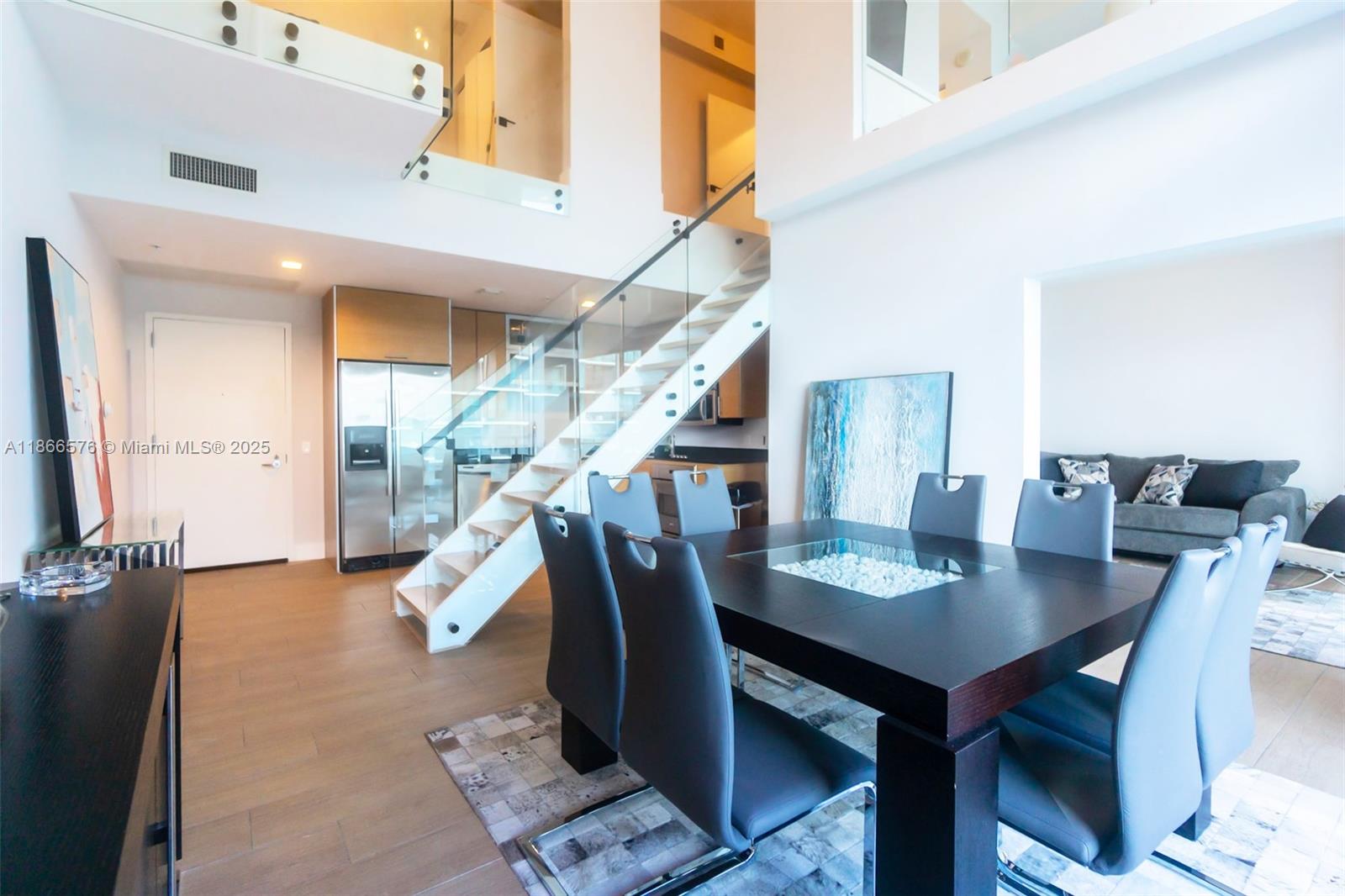 60 Southwest 13th Street, Unit 4802 Miami, FL 33130 - Photo 3 of 23 a view of a dining room with furniture