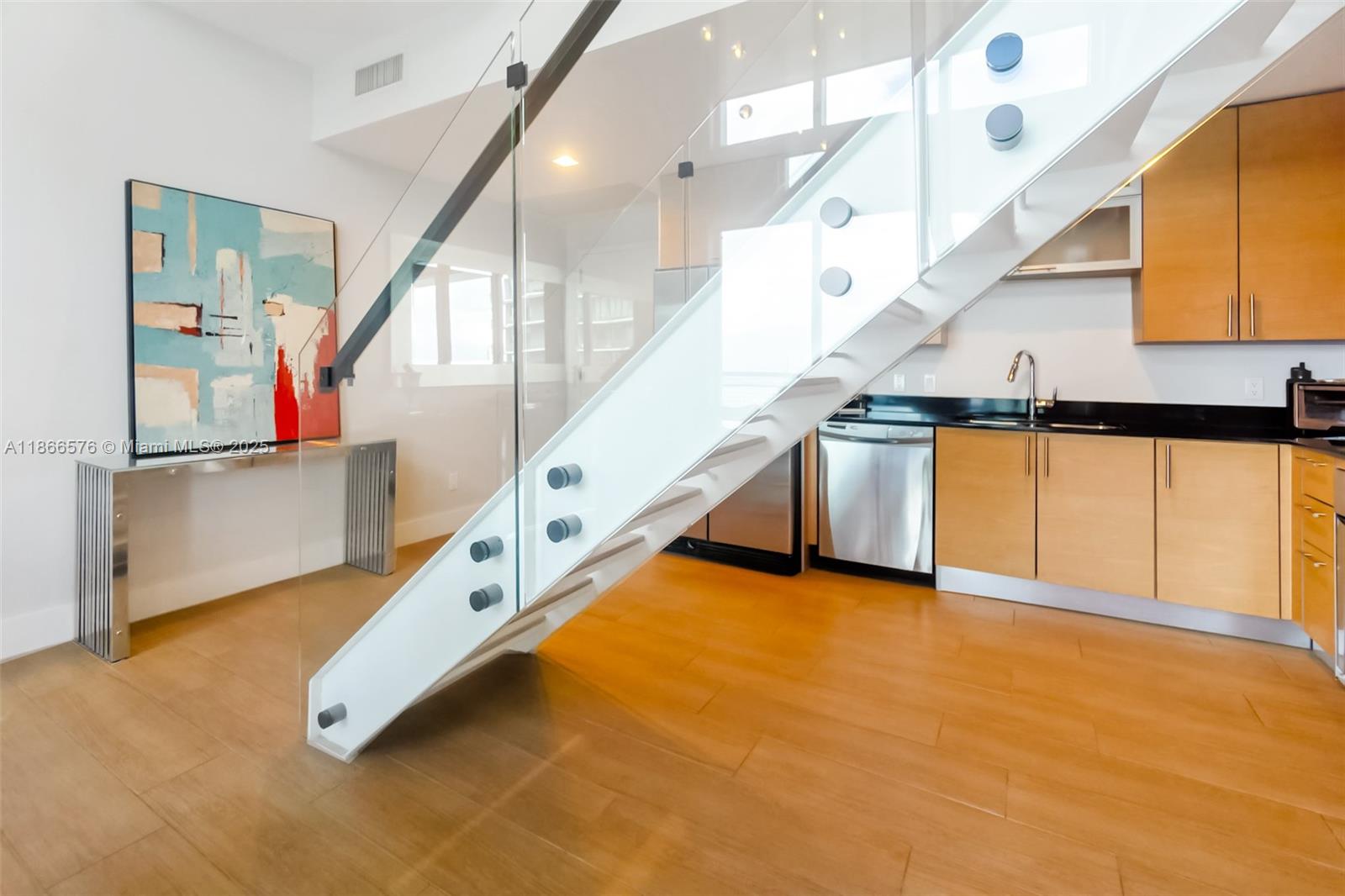 60 Southwest 13th Street, Unit 4802 Miami, FL 33130 - Photo 4 of 23 a view of an empty room with stairs
