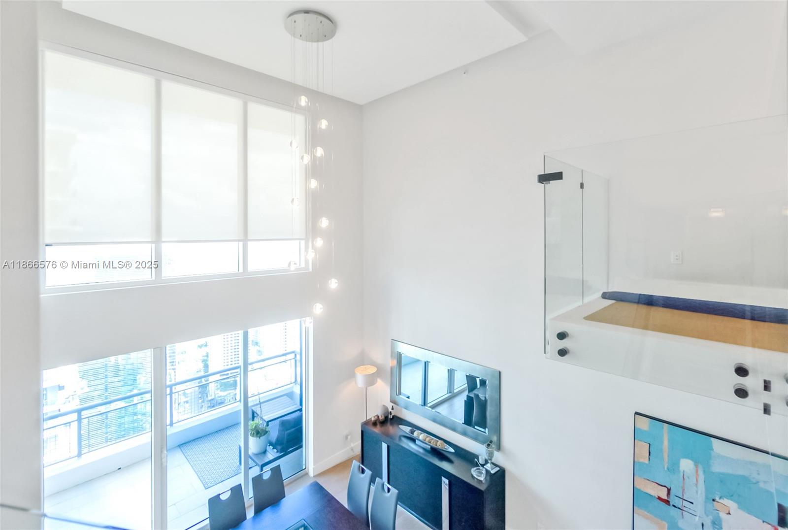 60 Southwest 13th Street, Unit 4802 Miami, FL 33130 - Photo 5 of 23 a view of an empty room with wooden floor and windows