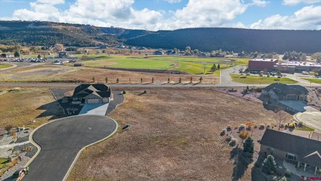 an aerial view of a house with a swimming pool yard and mountain view in back