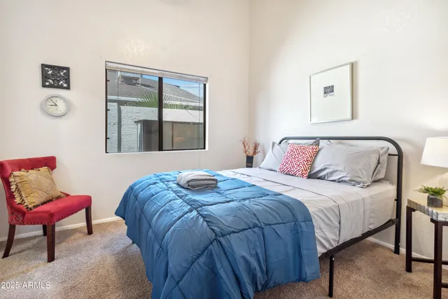 a bedroom with a bed and a chair