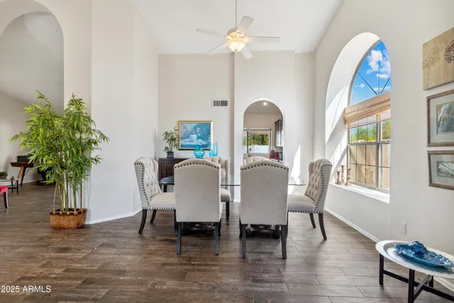 a living room with furniture a chandelier and a rug