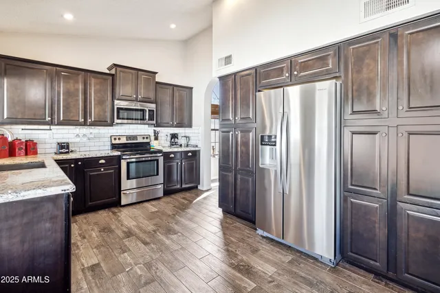 a living room with furniture a wooden floor and a window