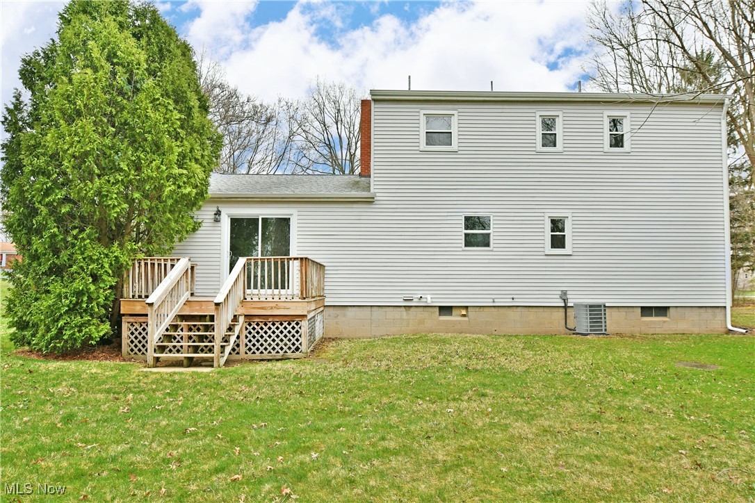2474 Johnny Cake Road Southeast Warren, OH 44484 - Photo 46 of 50 Back of property featuring a lawn, a deck, and central AC