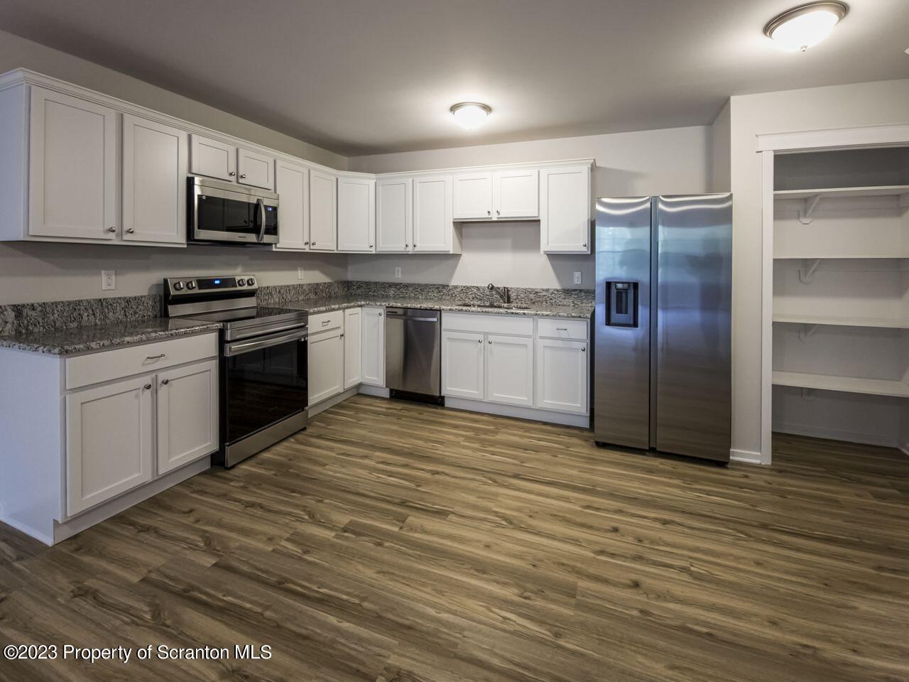 163 Bianca Way Old Forge, PA 18518 - Photo 6 of 24 a kitchen with stainless steel appliances granite countertop a stove a sink and a refrigerator