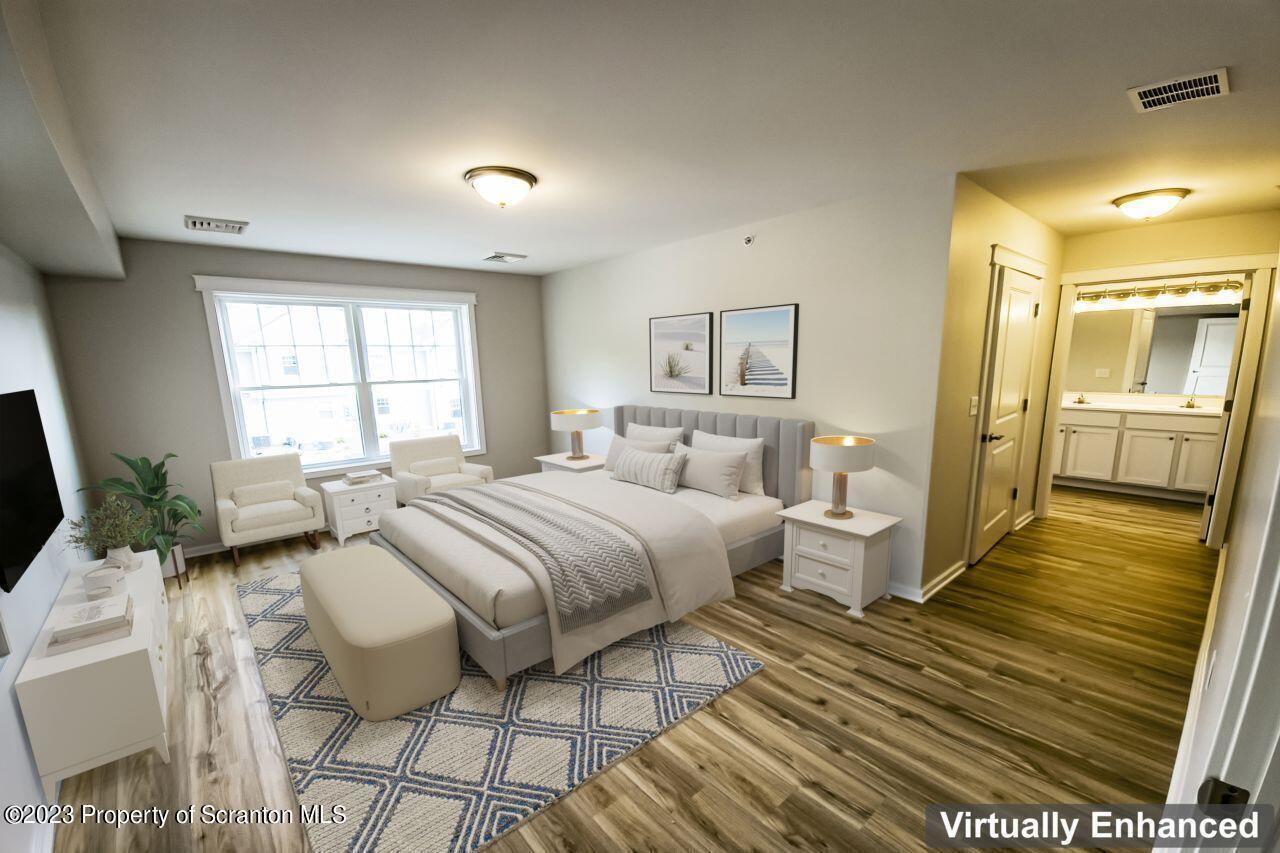163 Bianca Way Old Forge, PA 18518 - Photo 8 of 24 a spacious bedroom with two beds and a couch
