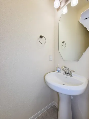 a bathroom with a sink a mirror and a toilet