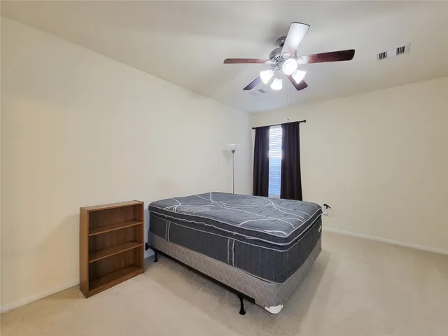 a room with a chandelier and a ceiling fan