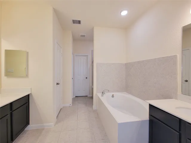 a bathroom with a bathtub and a sink