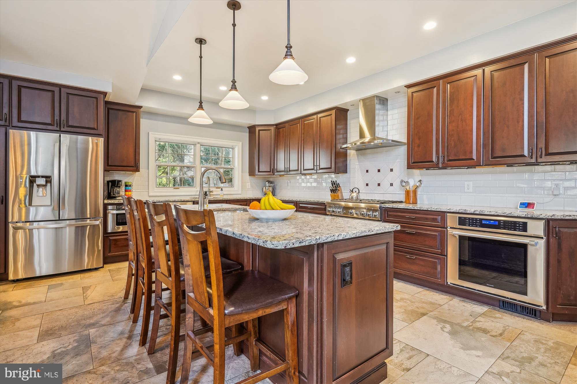 6100 Solitaire Way McLean, VA 22101 - Photo 13 of 60 a kitchen with granite countertop a stove a sink a oven a refrigerator and a dining table with wooden floor