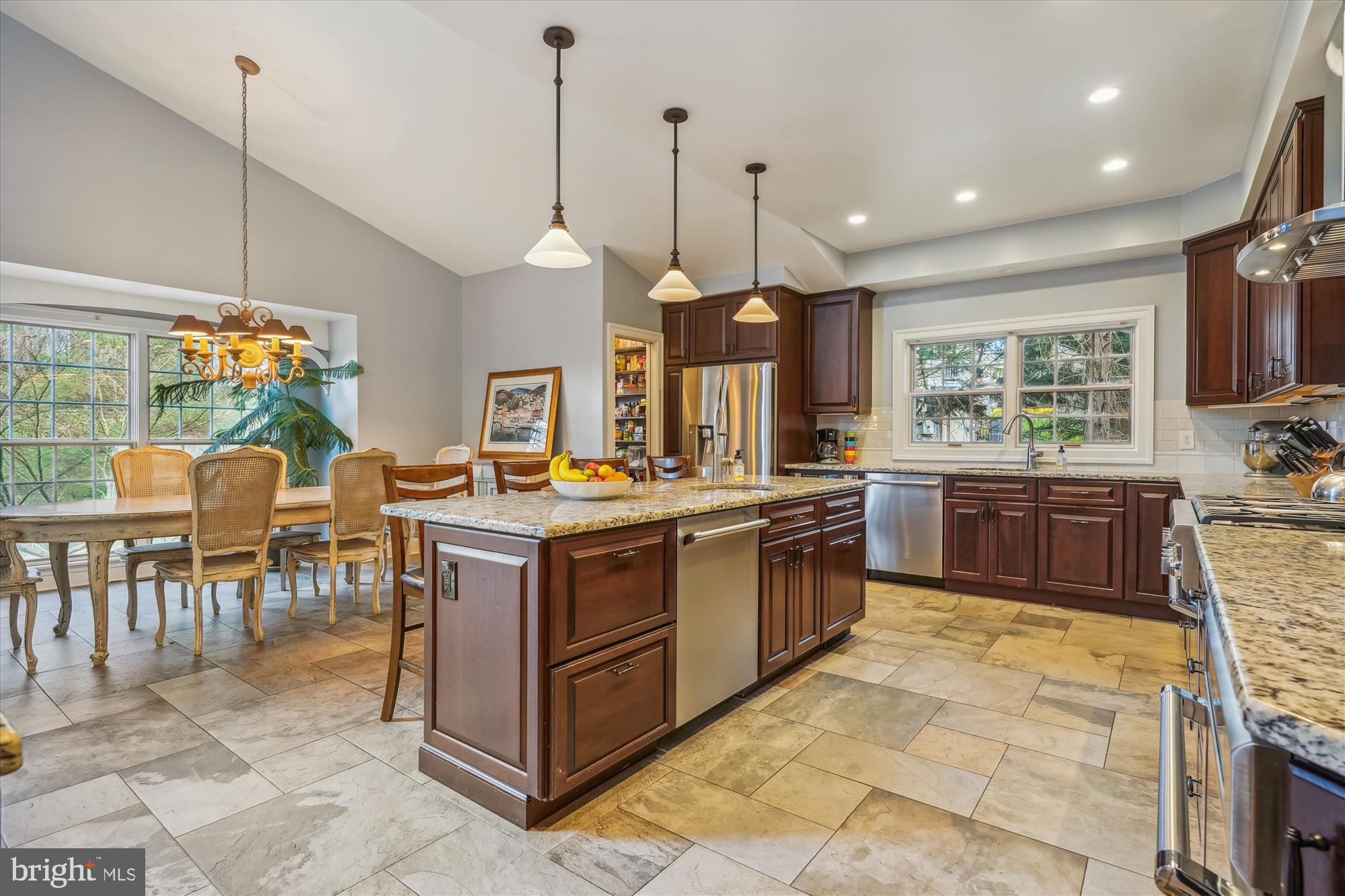 6100 Solitaire Way McLean, VA 22101 - Photo 3 of 60 a kitchen with stainless steel appliances granite countertop a stove a sink a oven a dining table and chairs
