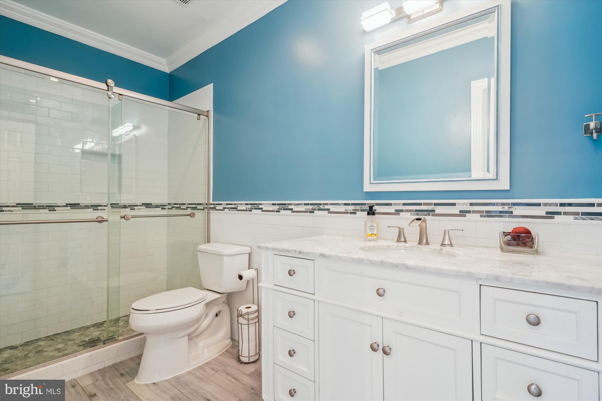 6100 Solitaire Way McLean, VA 22101 - Photo 37 of 60 a bathroom with a sink a toilet and a mirror