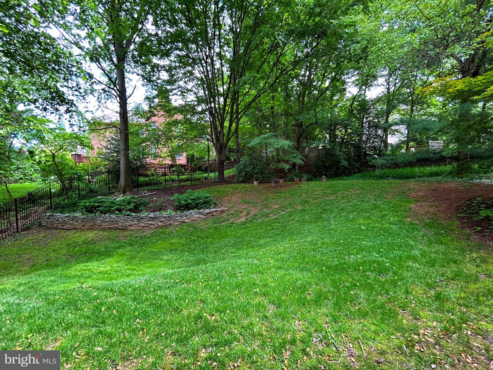 6100 Solitaire Way McLean, VA 22101 - Photo 57 of 60 a view of a grassy field with trees in the background