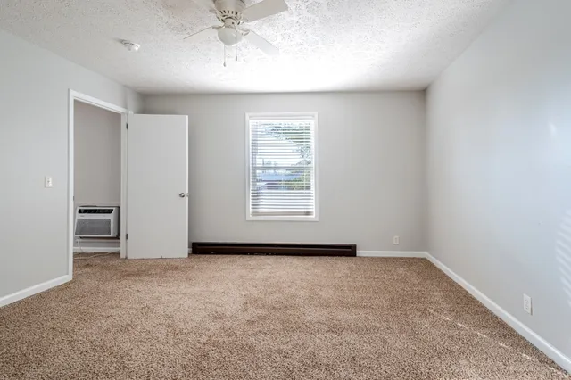 an empty room with a empty space and windows