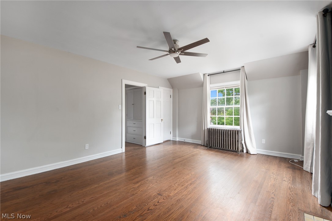 3133 Keswick Road Cleveland, OH 44120 - Photo 22 of 35 Unfurnished room featuring radiator, hardwood / wood-style flooring, vaulted ceiling, and ceiling fan
