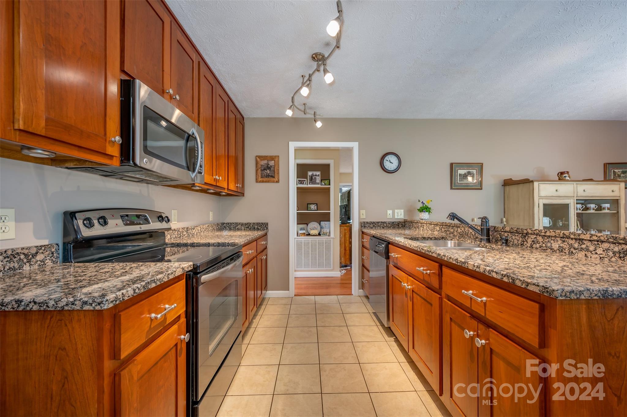 467 Lake Sandy Plains Road Tryon, NC 28782 - Photo 13 of 41 a large kitchen with stainless steel appliances granite countertop a stove sink and cabinets