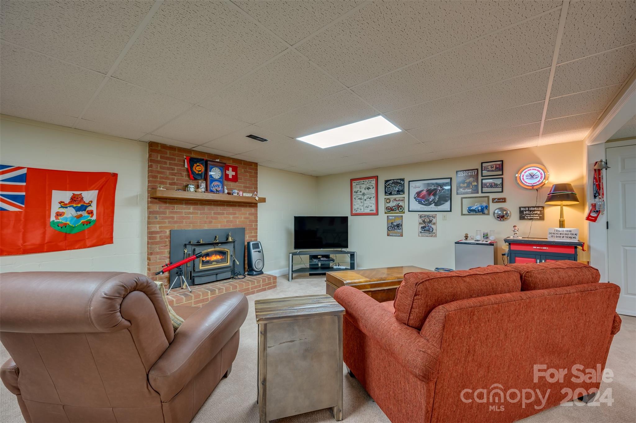 467 Lake Sandy Plains Road Tryon, NC 28782 - Photo 24 of 41 a living room with furniture a flat screen tv and a fireplace