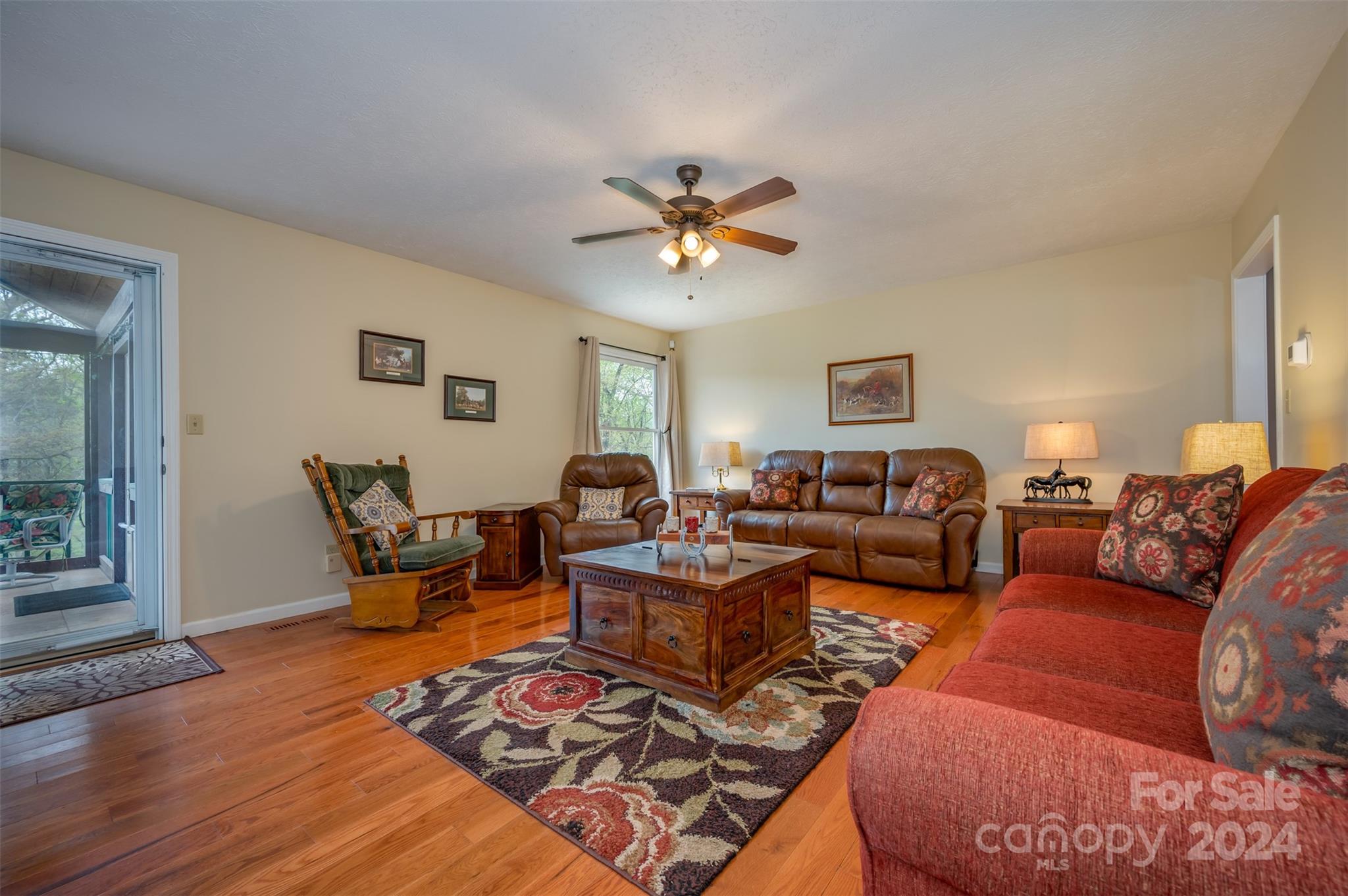 467 Lake Sandy Plains Road Tryon, NC 28782 - Photo 7 of 41 a living room with furniture ceiling fan and a rug