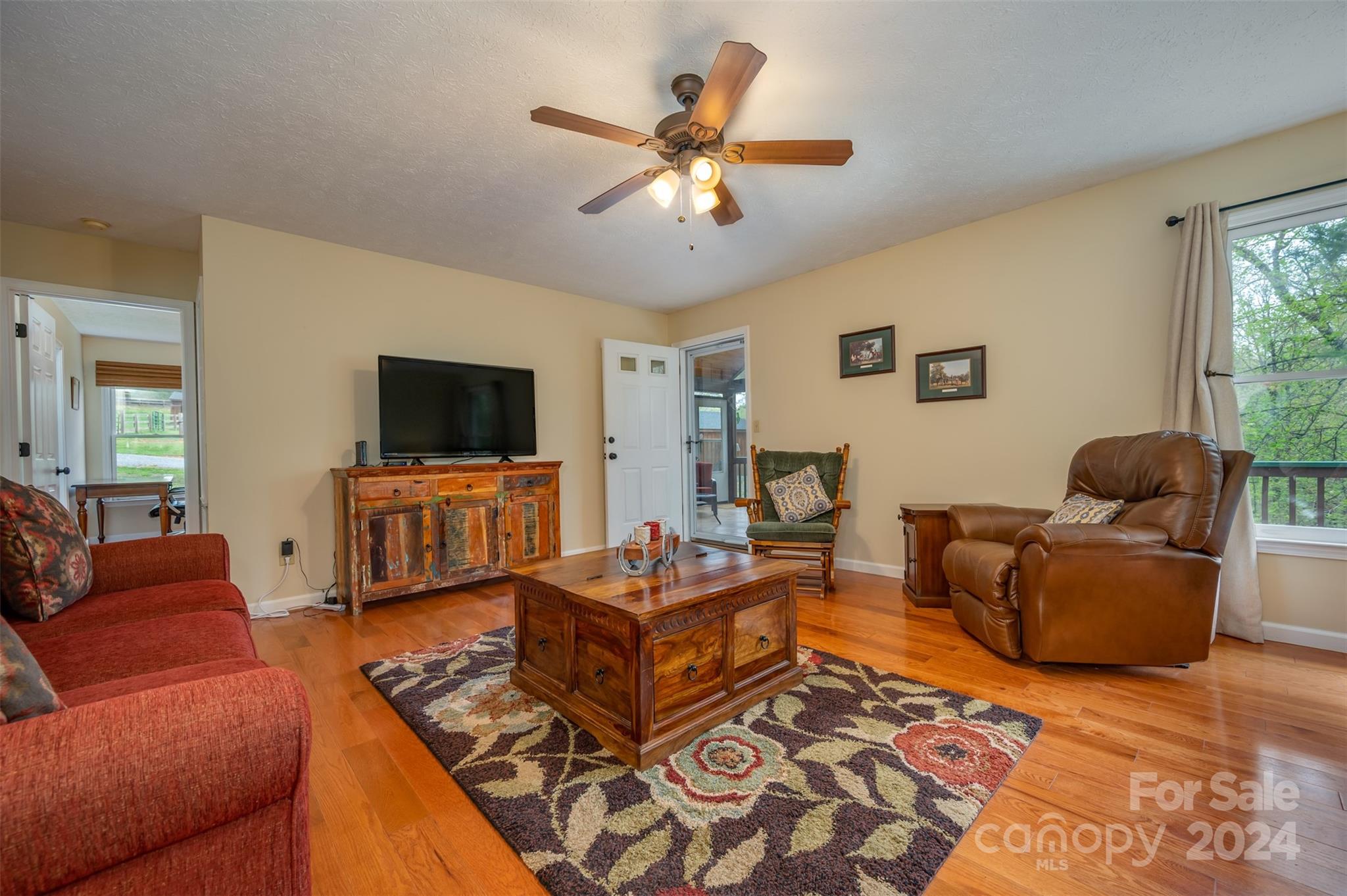 467 Lake Sandy Plains Road Tryon, NC 28782 - Photo 8 of 41 a living room with furniture and a flat screen tv