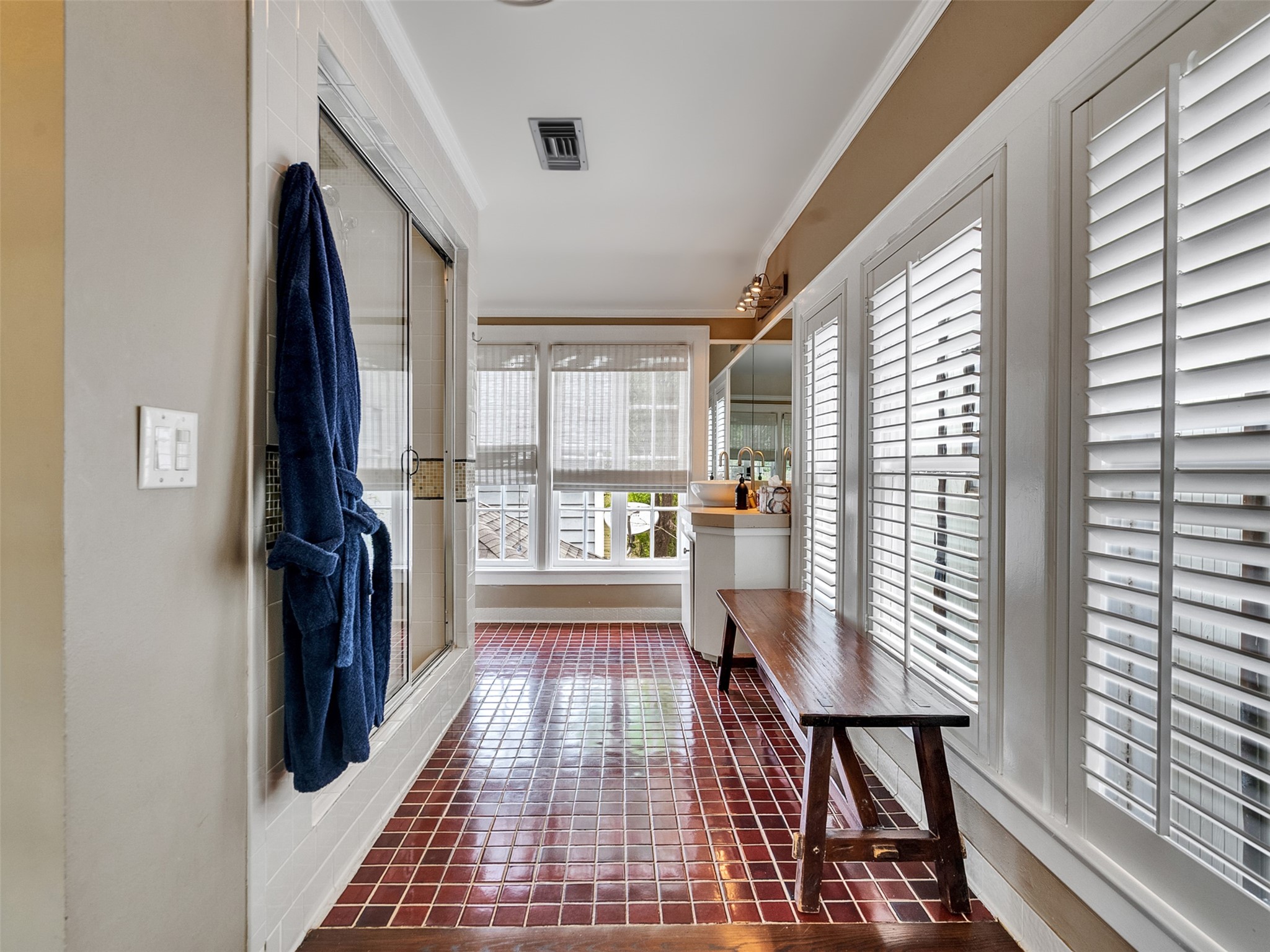 1836 Wroxton Road Houston, TX 77005 - Photo 25 of 42 Ensuite bathroom for third bedroom. Private and light-filled with windows and wooden shutters.
