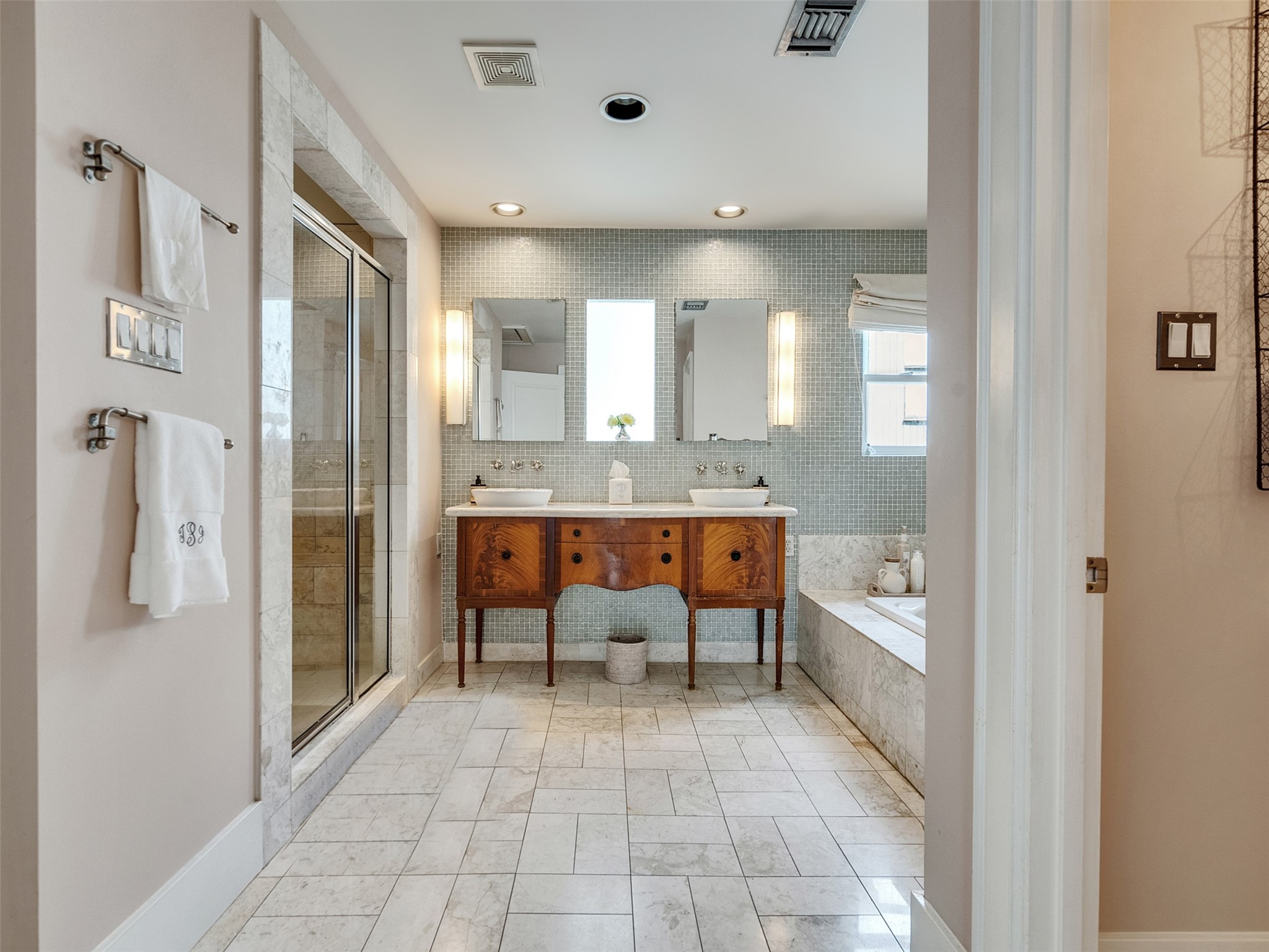 1836 Wroxton Road Houston, TX 77005 - Photo 32 of 42 Primary bath, marble floor and dual sinks, separate stand alone walk-in shower and soaking tub.