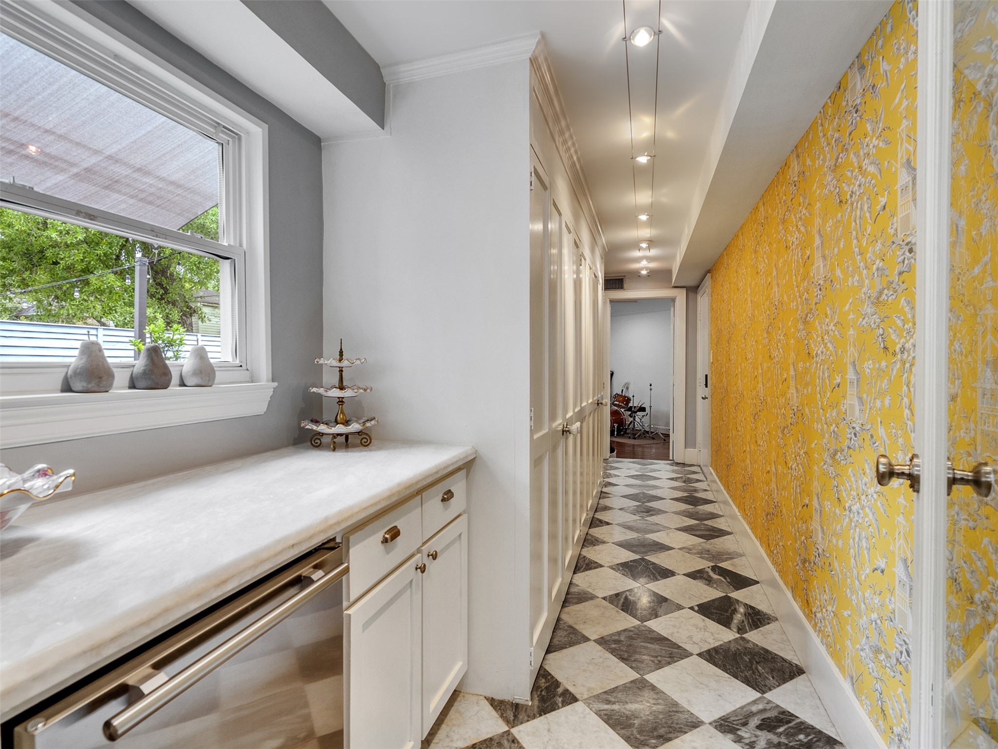 1836 Wroxton Road Houston, TX 77005 - Photo 33 of 42 Off the family room, there is a very convenient dry bar area with beverage fridge and quartzite counter. Just down the hall is the playroom/ flex room. Beautiful wallpaper and a marble tile floor finish off this space.