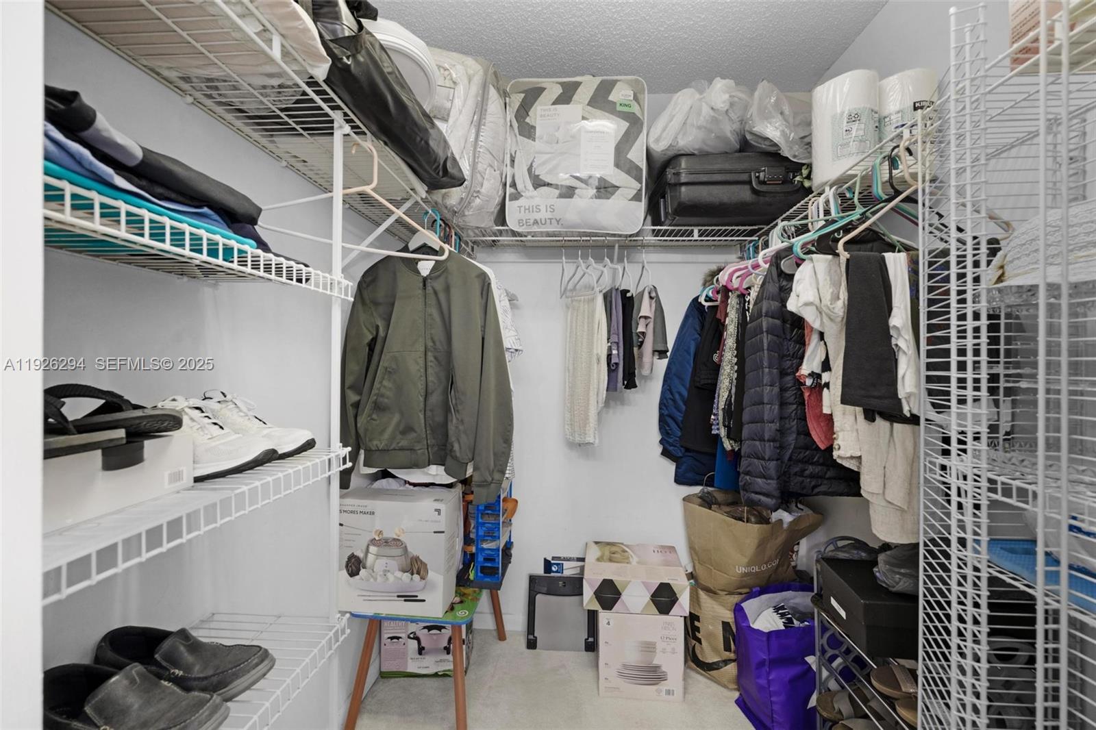 900 Southwest 142nd Avenue, Unit 306L Pembroke Pines, FL 33027 - Photo 12 of 34 a view of walk in closet with clothes and shoes