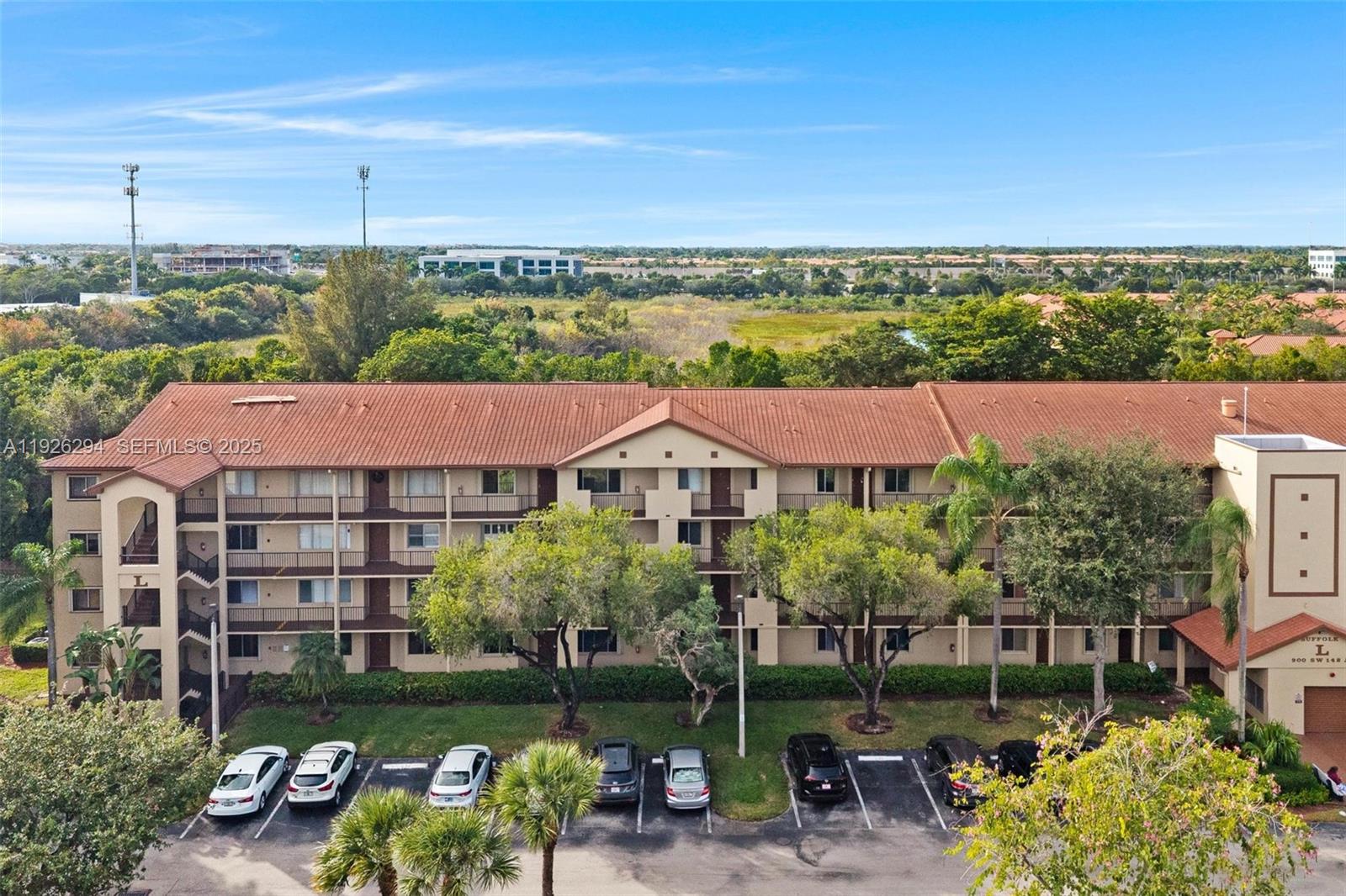 900 Southwest 142nd Avenue, Unit 306L Pembroke Pines, FL 33027 - Photo 2 of 34 a view of a patio next to a yard