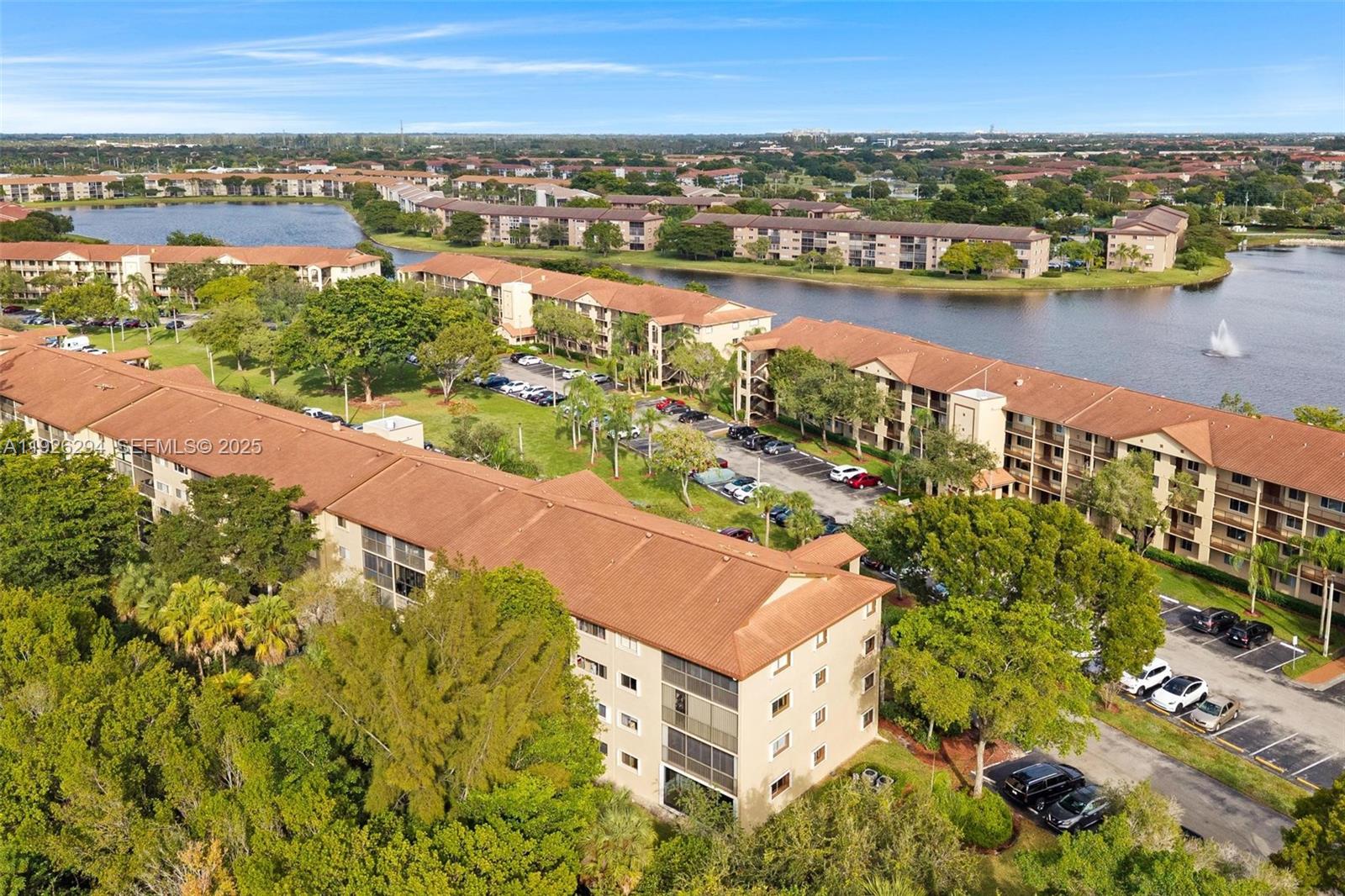900 Southwest 142nd Avenue, Unit 306L Pembroke Pines, FL 33027 - Photo 3 of 34 an aerial view of residential building and lake view