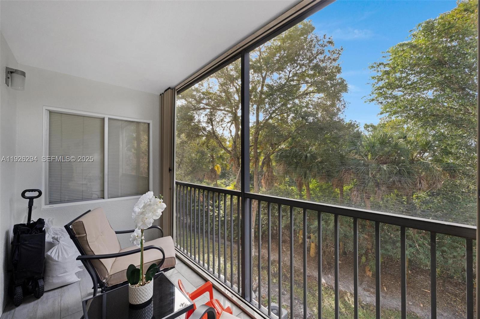900 Southwest 142nd Avenue, Unit 306L Pembroke Pines, FL 33027 - Photo 31 of 34 a view of a balcony with chair and floor to ceiling window