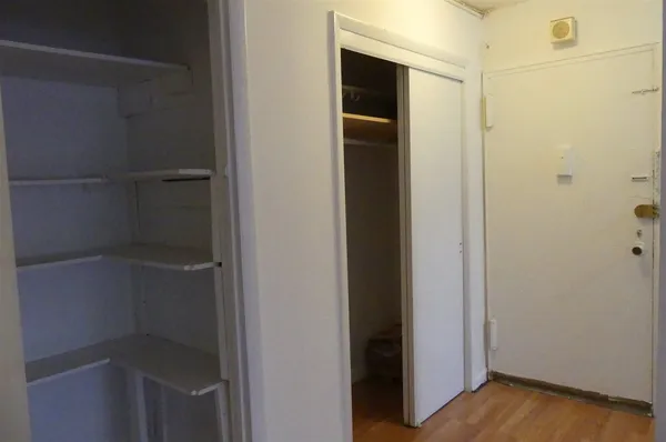 a view of hallway with wooden floor