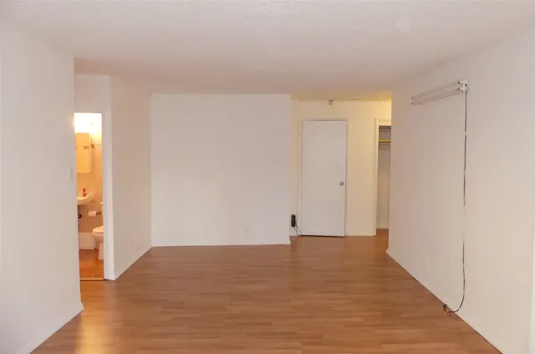a view of a room with wooden floor