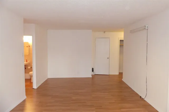 a view of a room with wooden floor
