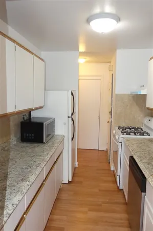 a kitchen with stainless steel appliances granite countertop a stove a refrigerator and a oven