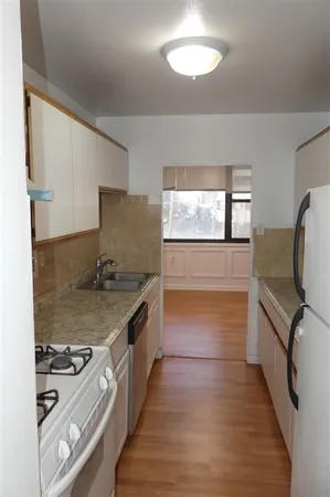 a kitchen with granite countertop a stove and a refrigerator