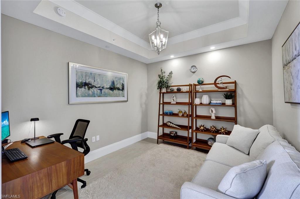 1035 3rd Avenue South, Unit 514 Naples, FL 34102 - Photo 11 of 35 a view of a livingroom with a couch and a bookshelf