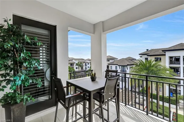 a view of balcony with furniture and potted plants