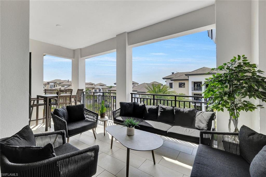 1035 3rd Avenue South, Unit 514 Naples, FL 34102 - Photo 14 of 35 a living room with furniture and a floor to ceiling window