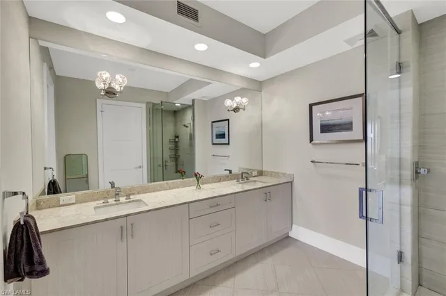 a bathroom with a double vanity sink and a mirror