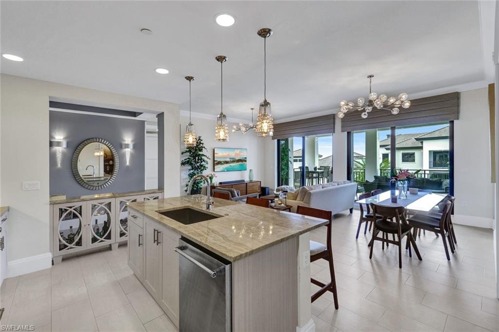 1035 3rd Avenue South, Unit 514 Naples, FL 34102 - Photo 2 of 35 a view of a dining room and livingroom with furniture wooden floor a chandelier