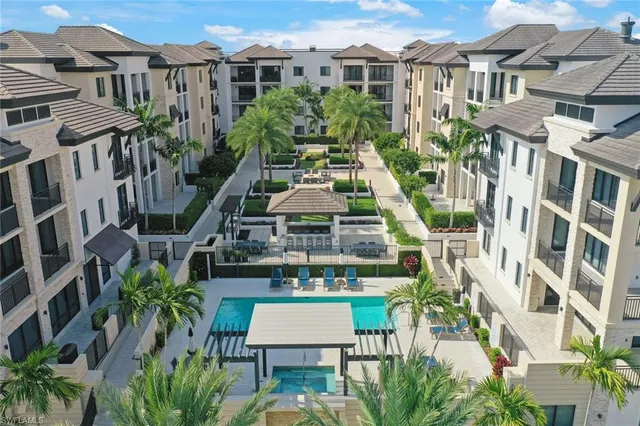 a aerial view of a house with a yard and potted plants