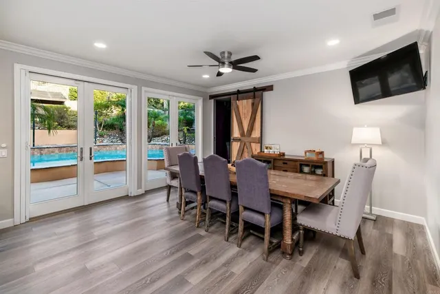 a view of a dining room with furniture window and wooden floor