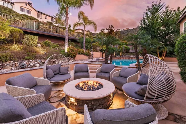 a view of a patio with couches chairs and a fire pit