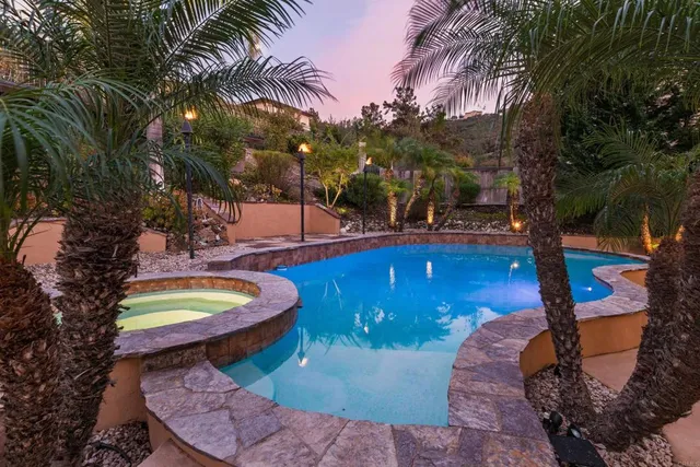 a view of a backyard with swimming pool