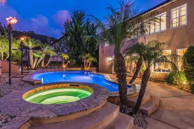 a view of a swimming pool with sitting area